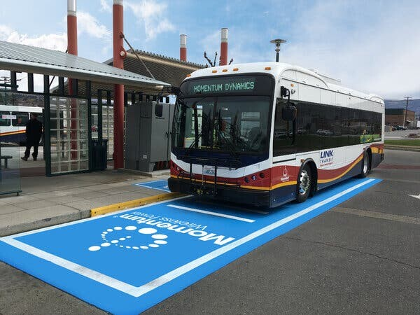 An electric bus charging wirelessly during a route stop in Wenatchee, Wash.