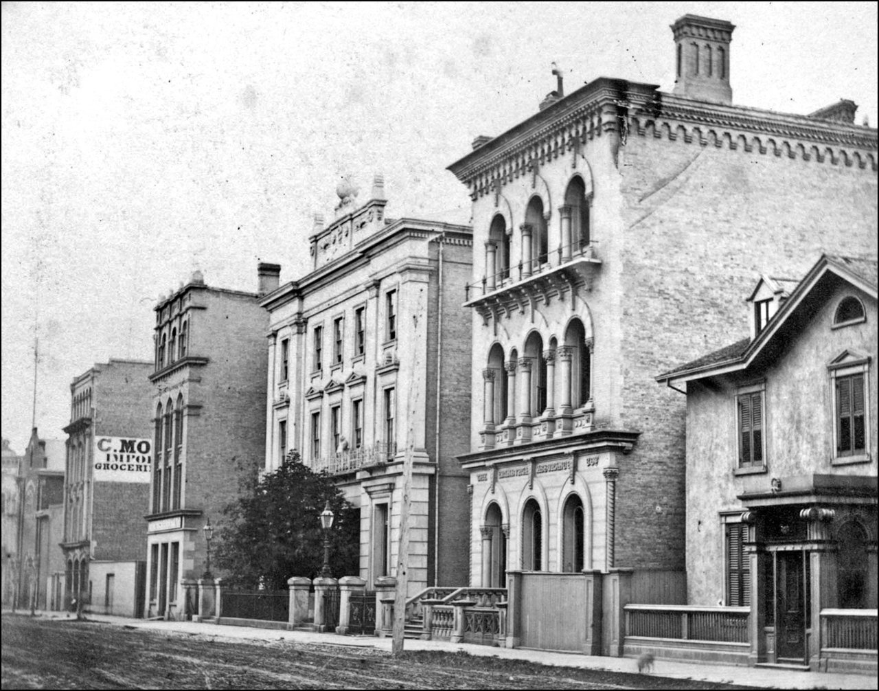 Wellington St. W., south side, looking east to Yonge St. 1867  TPL.jpg