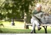 senior_man_reading_newspaper_on_park_bench_DWH07090.jpg