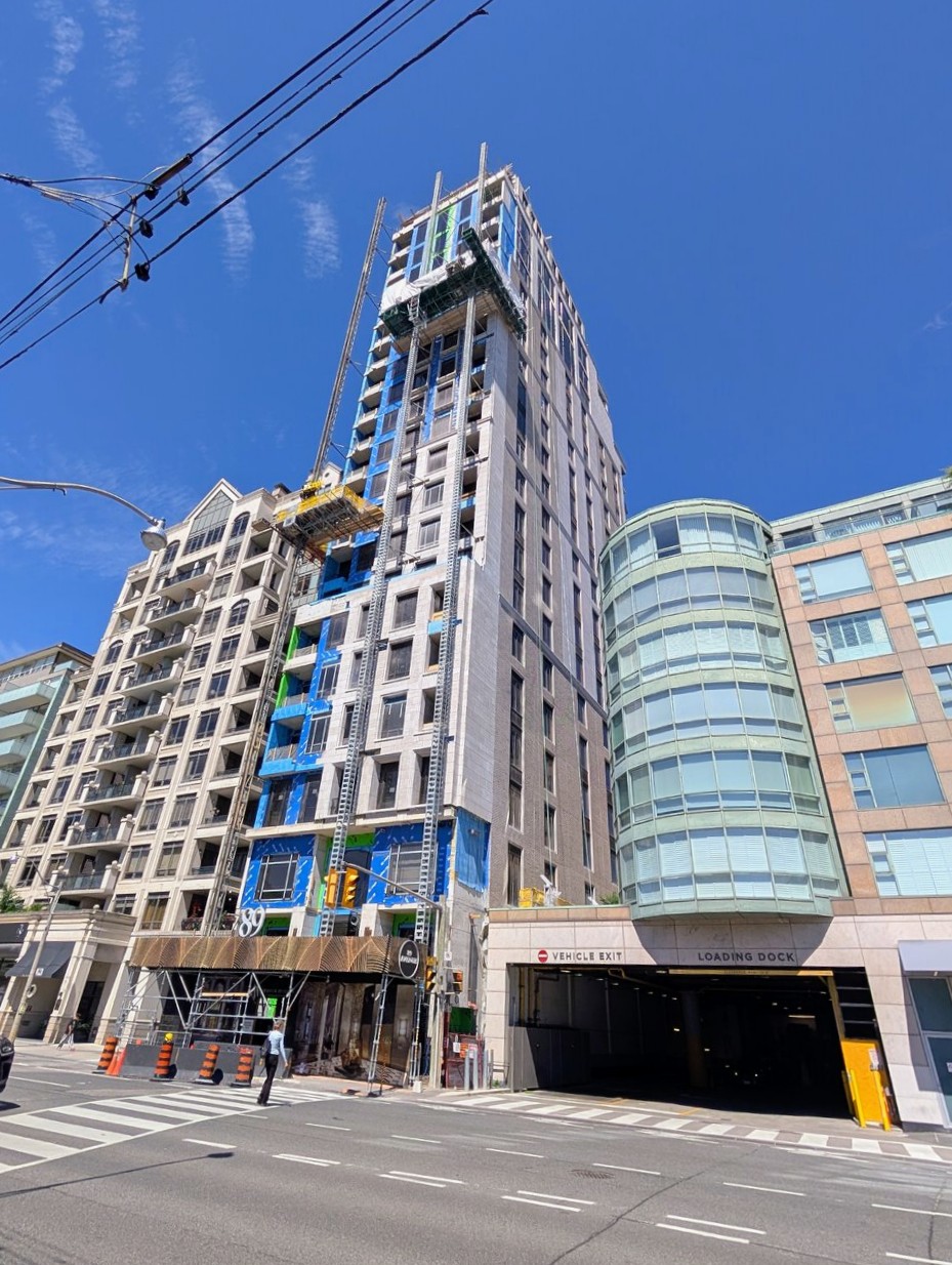 Two mast-climbing work platforms supporting facade installation on the west elevation of 89 Avenue Yorkville