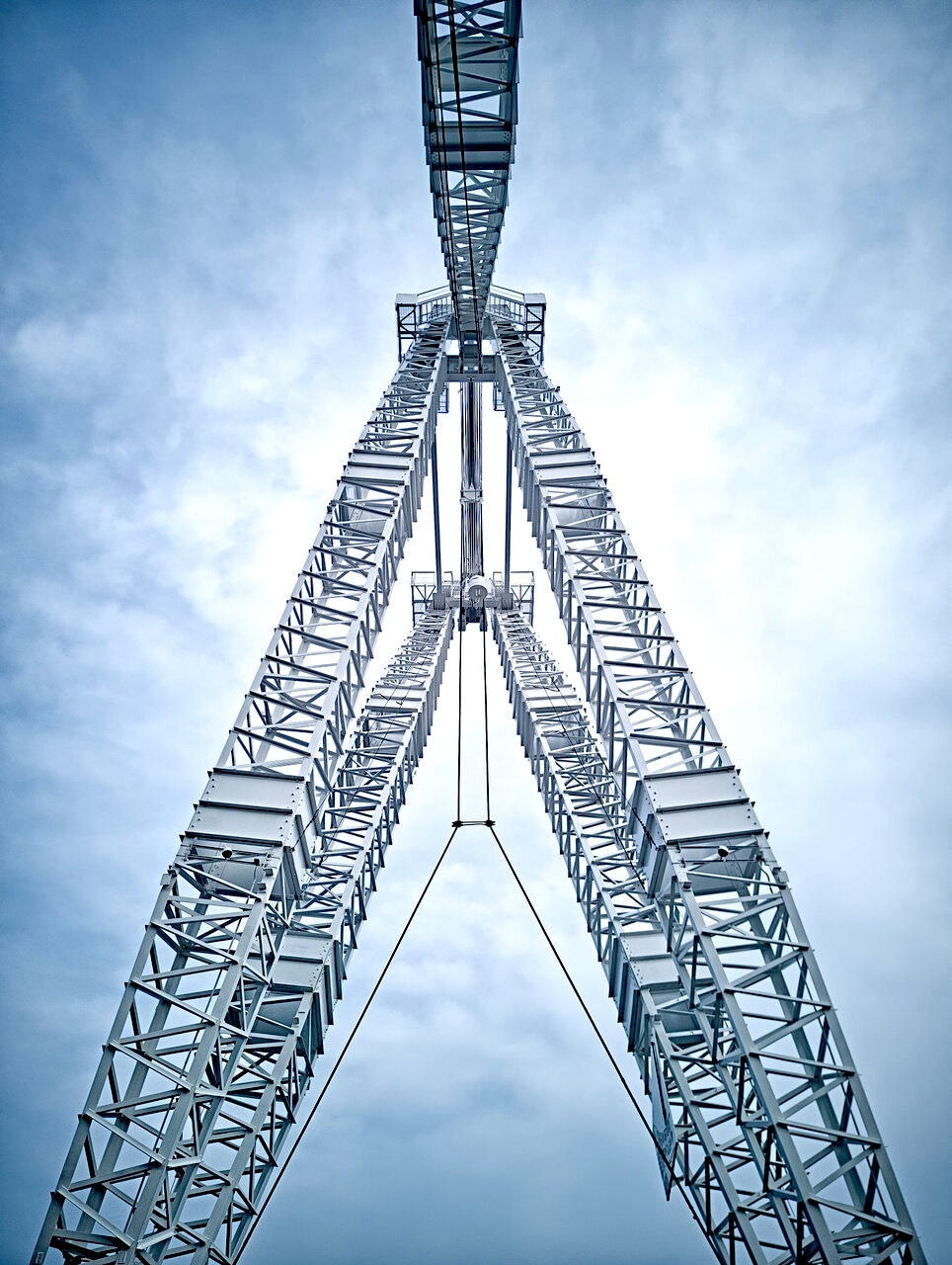 Looking up through the masts of the restored Atlas crane at the new Biidaasige Park extension in Toronto