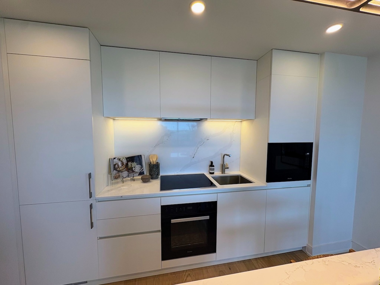Italian-manufactured kitchen with flat-panel cabinetry inside a One Delisle model suite
