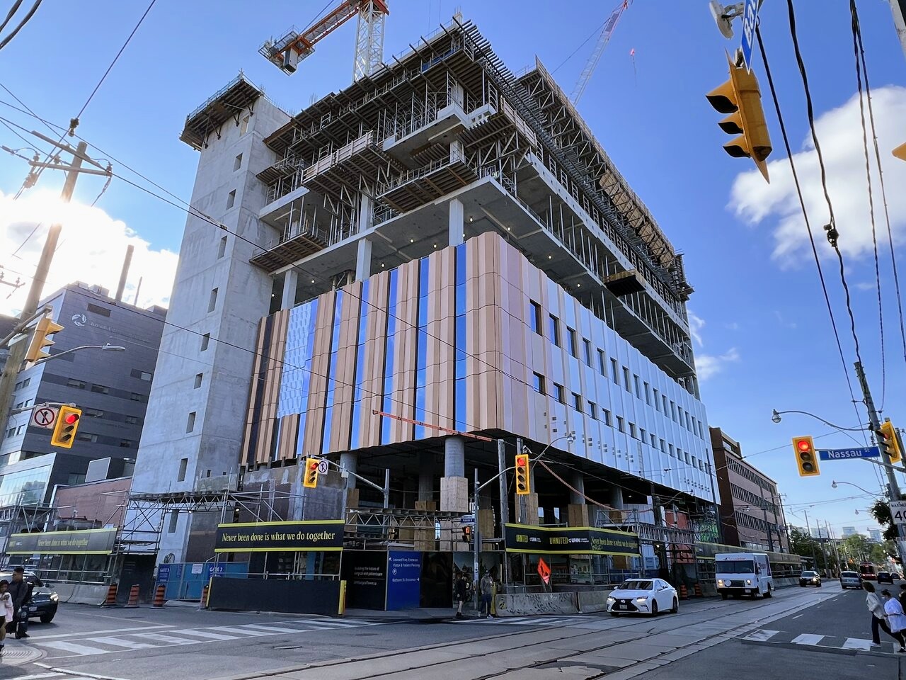 Colourful metal cladding and window panels installed on lower floors of the Toronto Western Hospital Patient Care Tower